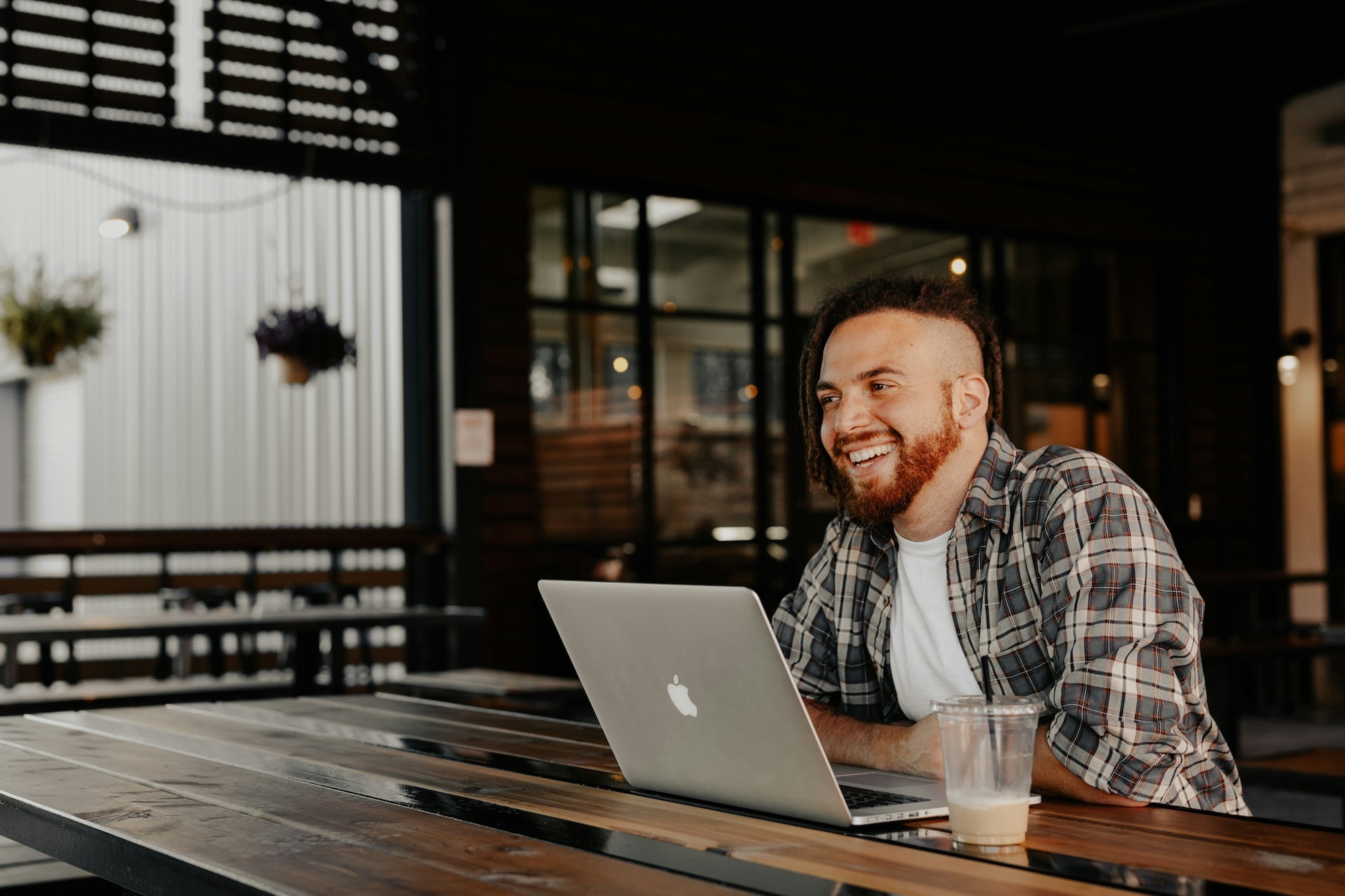 Chicago Web Co web design services - professional man working on laptop at outdoor cafe with evening atmosphere, showcasing remote work and digital solutions
