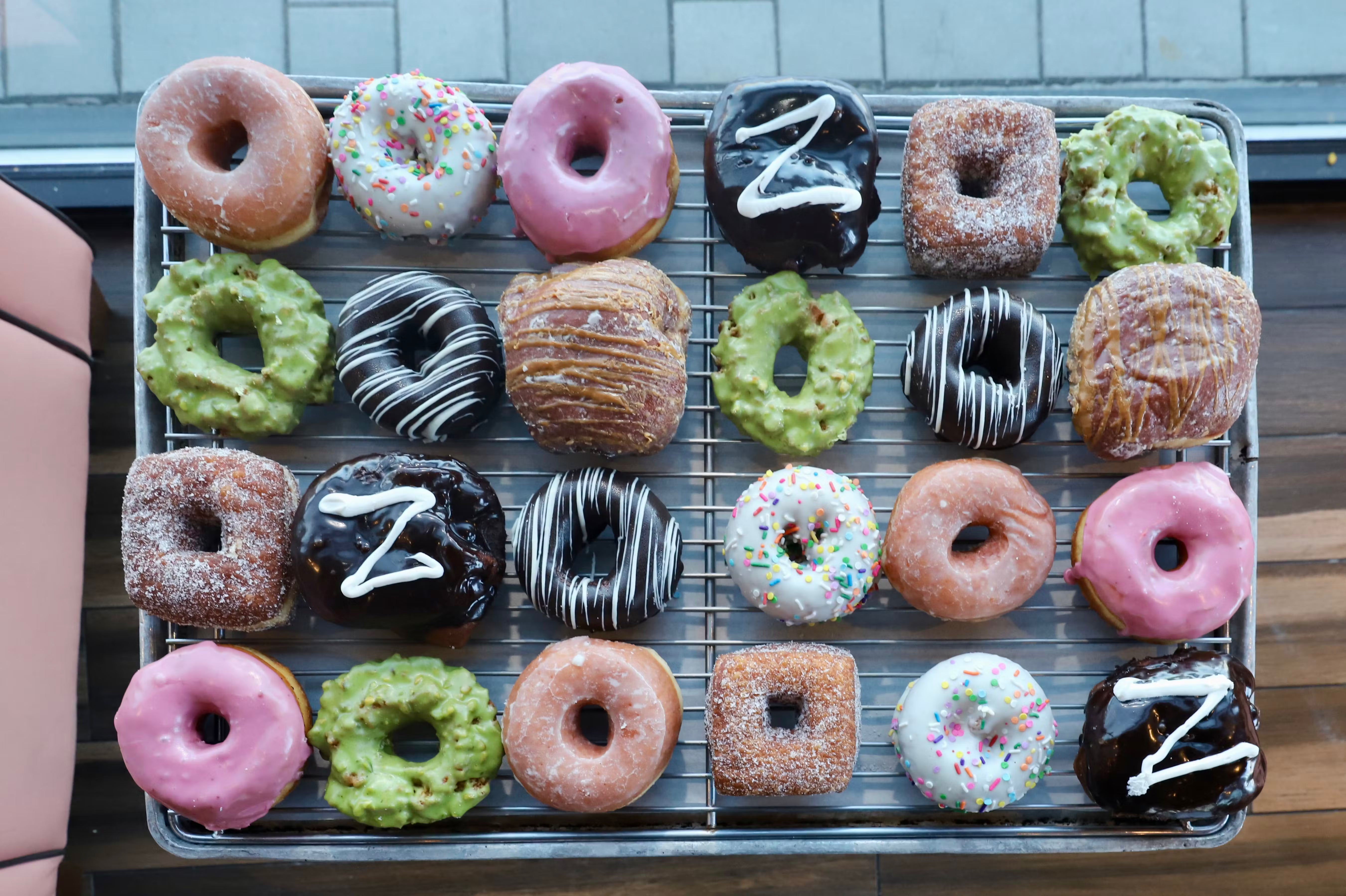 Chicago Web Co web design for Stan's Donuts - assorted fresh donuts including glazed, frosted, and green frosting varieties on cooling rack display